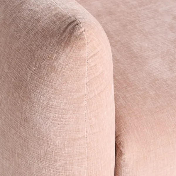 Close-up of blush pink fabric texture on lounge chair arm