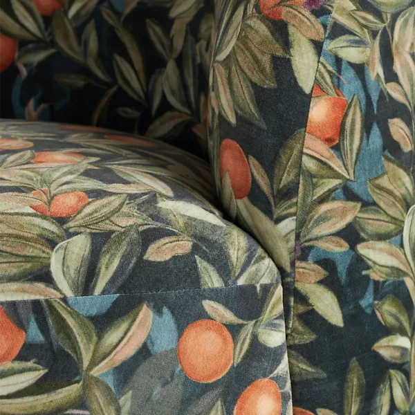 orange and leaf botanical upholstery detail on round lounge chair