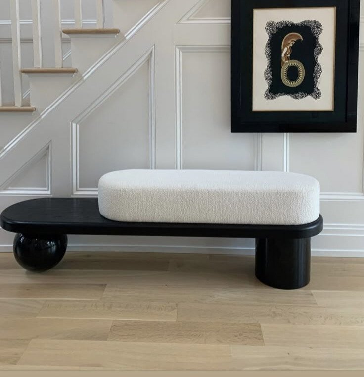 Modern black bench with white cushioned seat