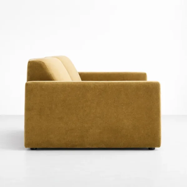 Side view of mustard velvet sofa showing its modern silhouette by INTERIORZE