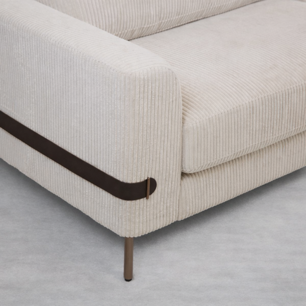 Close-up of leather strap detail on ivory corduroy 3 seater sofa arm