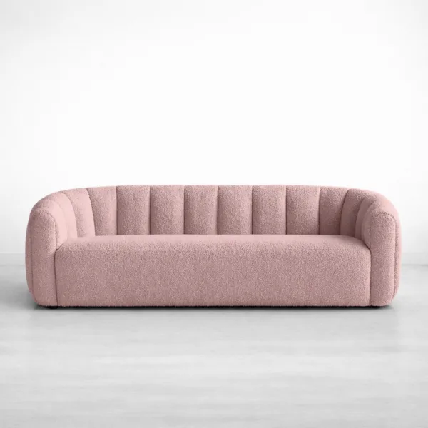 Front view of INTERIORZE Aisha pink boucle 3 seater sofa with curved back and channel upholstery