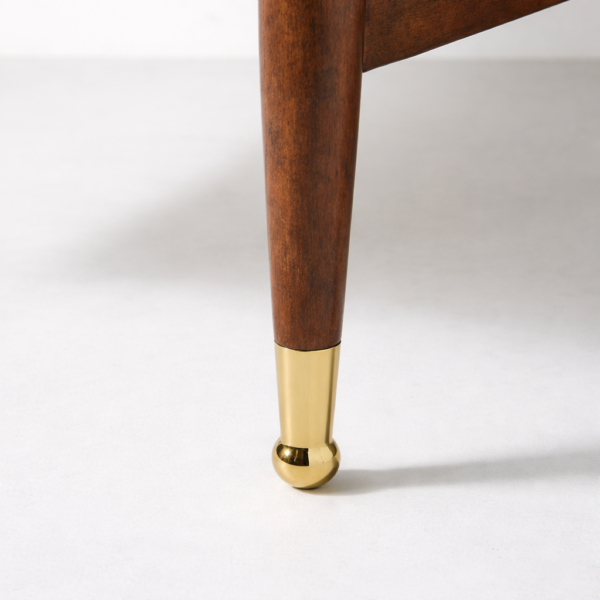 Gold metal leg caps detail on teakwood cane accent chair