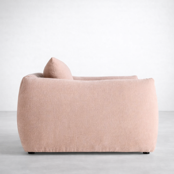 Side view of INTERIORZE blush pink lounge chair with oversized arms