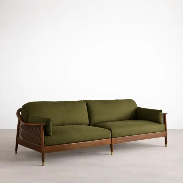 Angled view of teakwood cane sofa with cane side panel and olive green upholstery