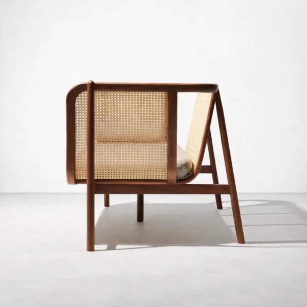 Side view of teakwood rattan sofa showing cane panel work and teakwood frame by INTERIORZE