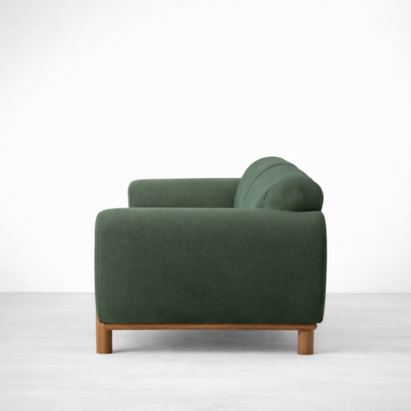 Side view of green ash wood sofa with rounded arm and ash wood support by INTERIORZE