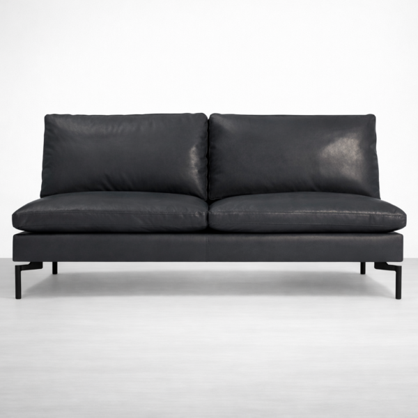 Front view of black leather sofa with supportive cushions and metal legs by INTERIORZE