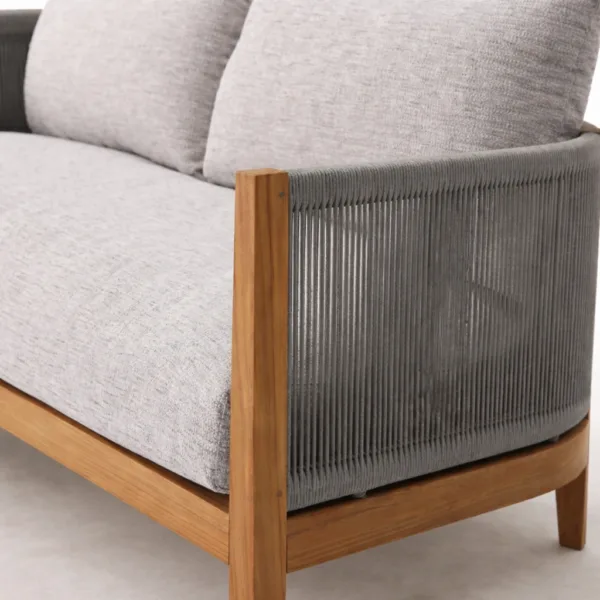 Close up of charcoal rope side panel and teak arm on INTERIORZE Kiaan teak wood rope 3 seater sofa