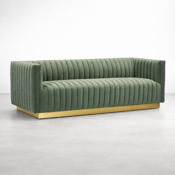 Green velvet channel tufted sofa with gold base by Interiorze