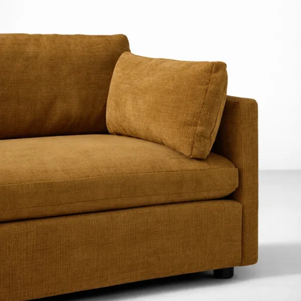 Close-up of mustard brown fabric upholstery and cushion on INTERIORZE Arlo sofa