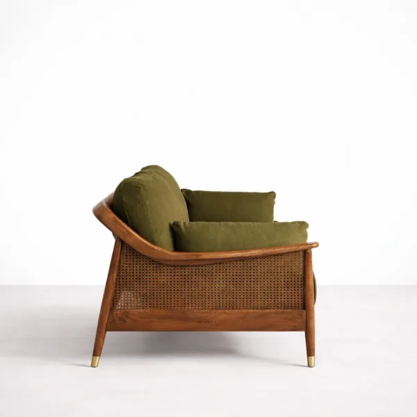 Teakwood cane sofa side view with olive green upholstery and cane panel