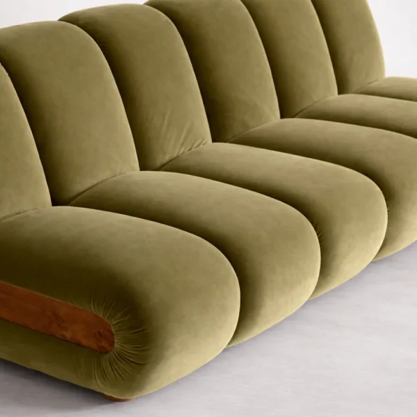 Close-up of teakwood green sofa showing channel tuft upholstery and soft fabric texture