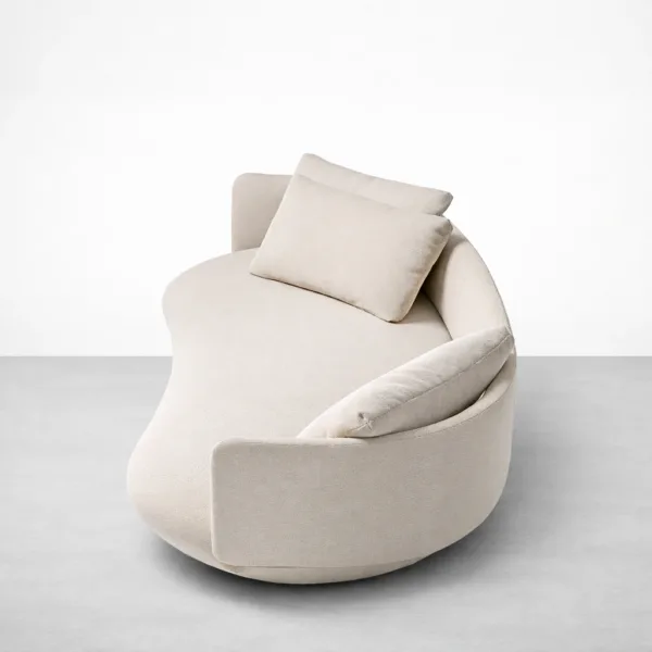 Ivory curved sofa side angle view showing rounded arms and deep seat by INTERIORZE