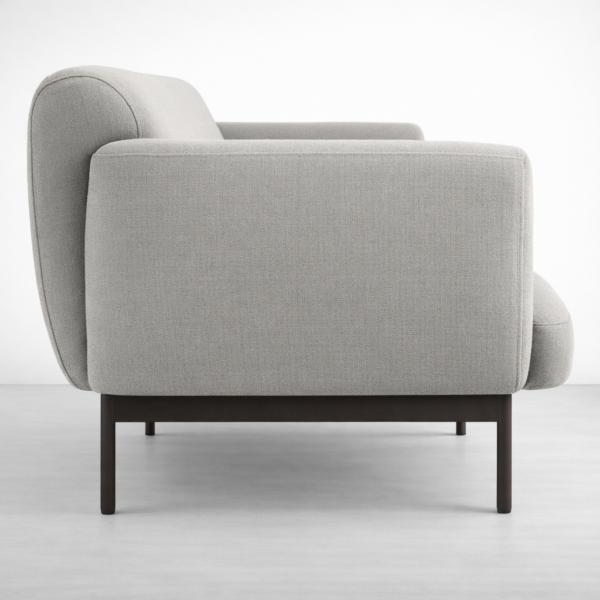 Side view of grey linen sofa with metal base and rounded arms by Interiorze