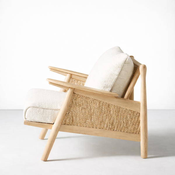 Side view of INTERIORZE ash wood cane lounge chair with cream cushions