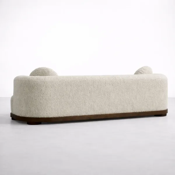 Teakwood boucle sofa back view in ivory with teakwood base and rounded corners