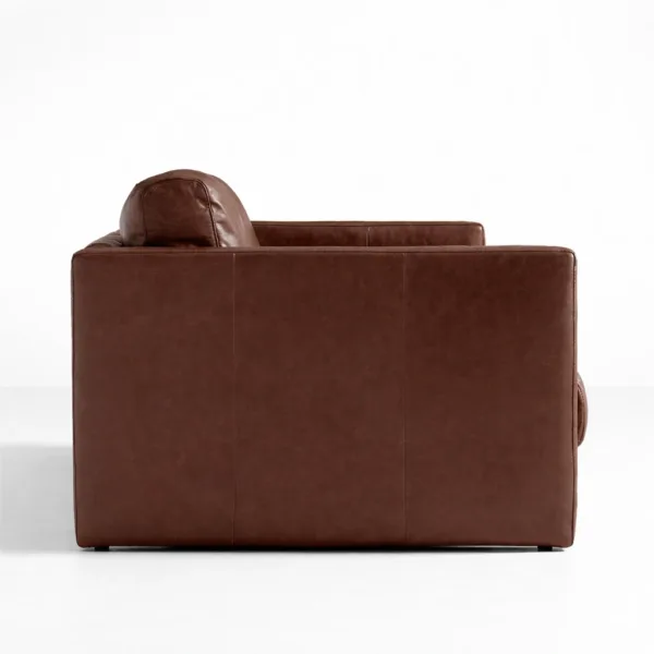 Side view of brown leather sofa with structured arm design by INTERIORZE