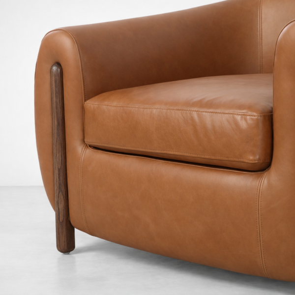 tan leather armchair teakwood legs dark walnut polish detail