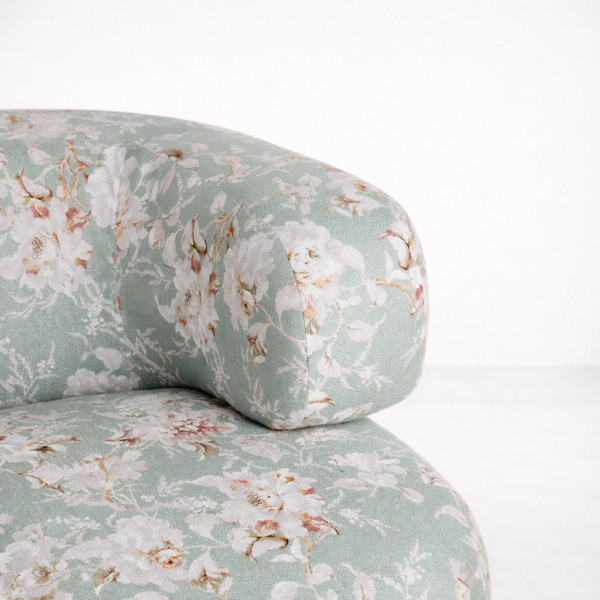 Close-up of sage green floral fabric on INTERIORZE round accent chair