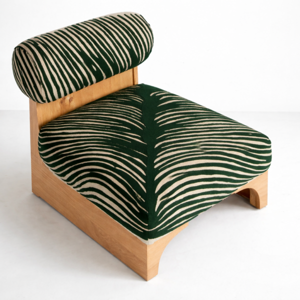 Angled top view of teakwood green zebra print lounge chair with low seat and roll backrest