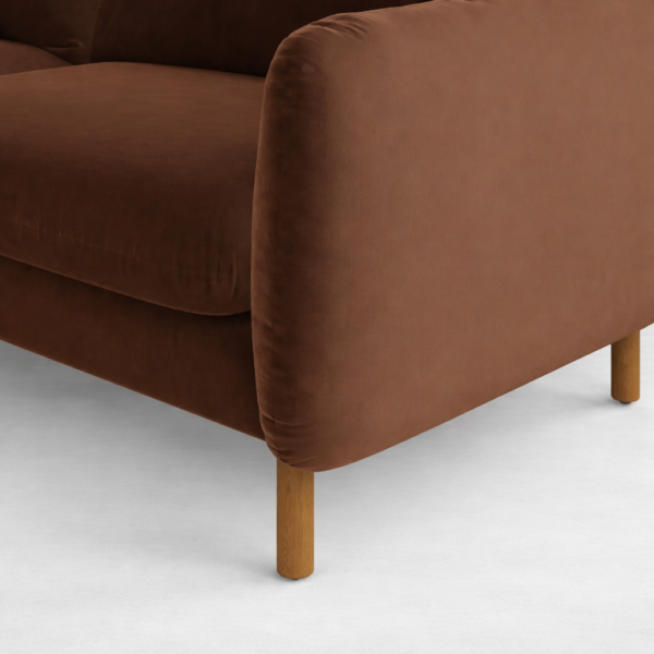 Close-up of brown velvet sofa arm and seat cushion detail by INTERIORZE