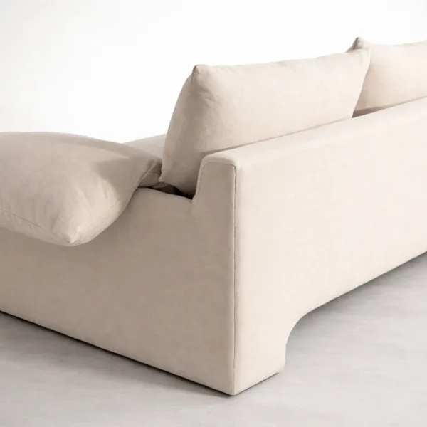 Close-up of teakwood cream sofa corner showing fabric texture and cushion detailing