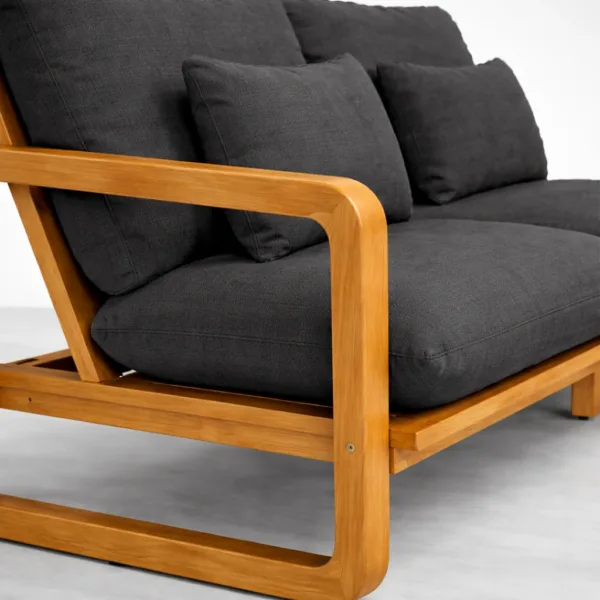 Black teak wood sofa arm close-up with charcoal cushions INTERIORZE Nero