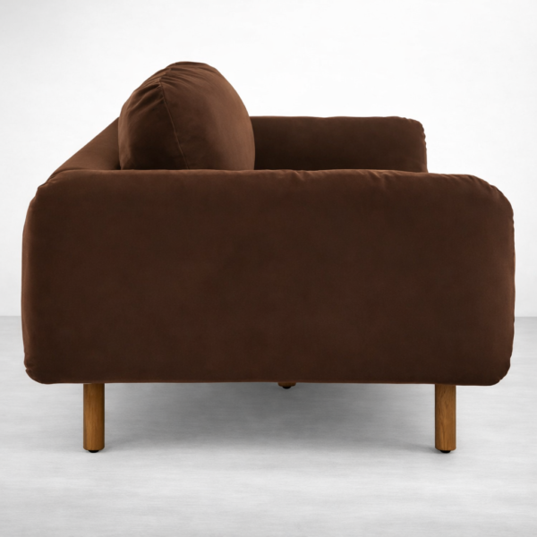 Side view of brown velvet 3 seater sofa with rounded arm and teakwood legs by INTERIORZE