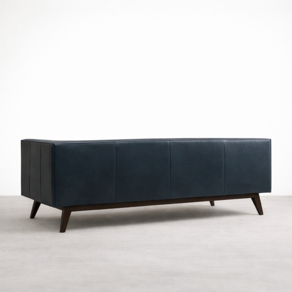 Back view of navy blue tufted leather sofa with teakwood legs by Interiorze