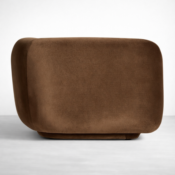 Side view of brown velvet curved sofa with rounded end by Interiorze