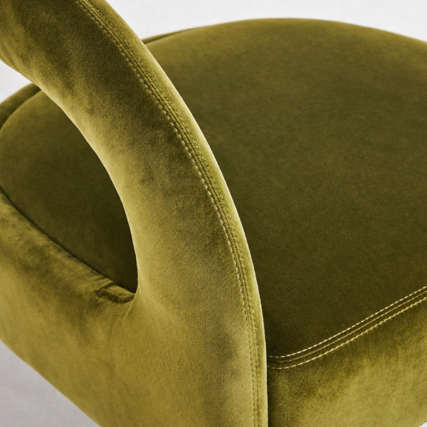 Close-up of olive green velvet upholstery on lounge chair seat and back