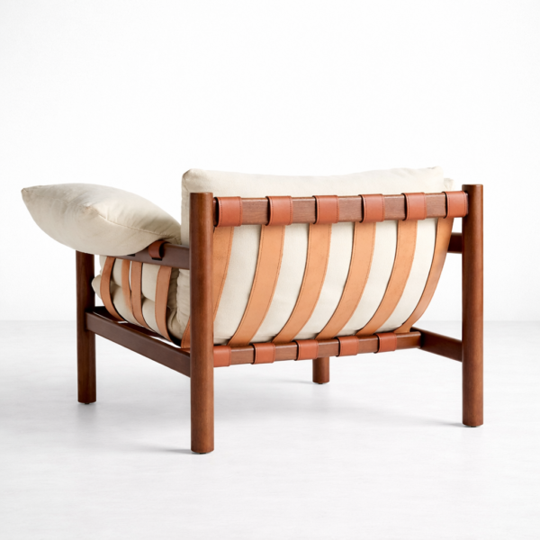lounge chair with teakwood frame and tan leather strap bac