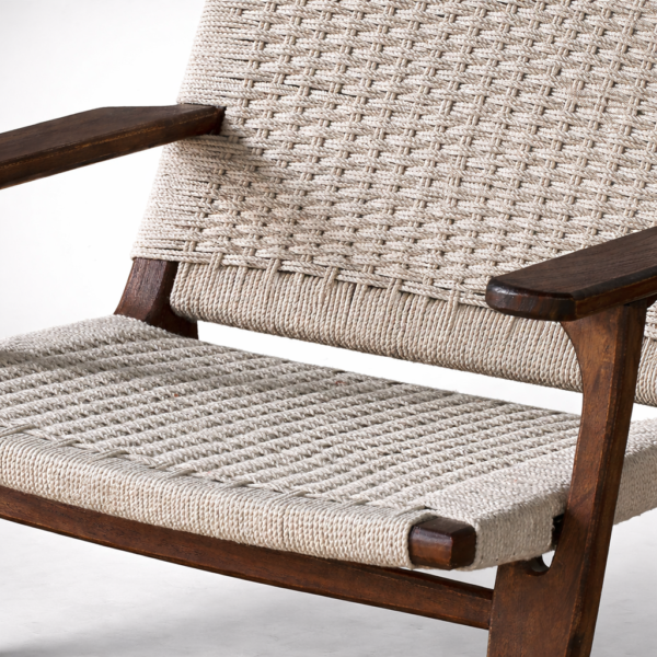 Close-up of handwoven natural rope seat and back on wooden lounge chair