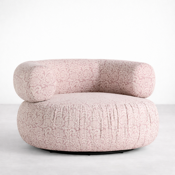 Blush pink floral swivel chair with deep seat and wraparound backrest