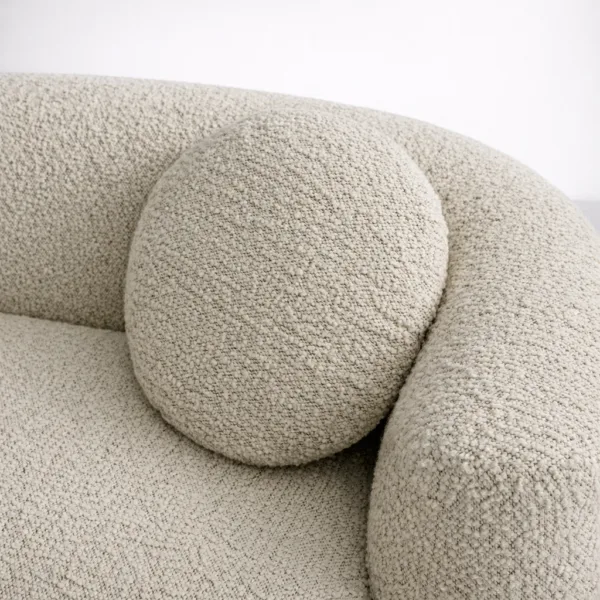 Close-up of ivory boucle fabric texture on teakwood boucle sofa cushion