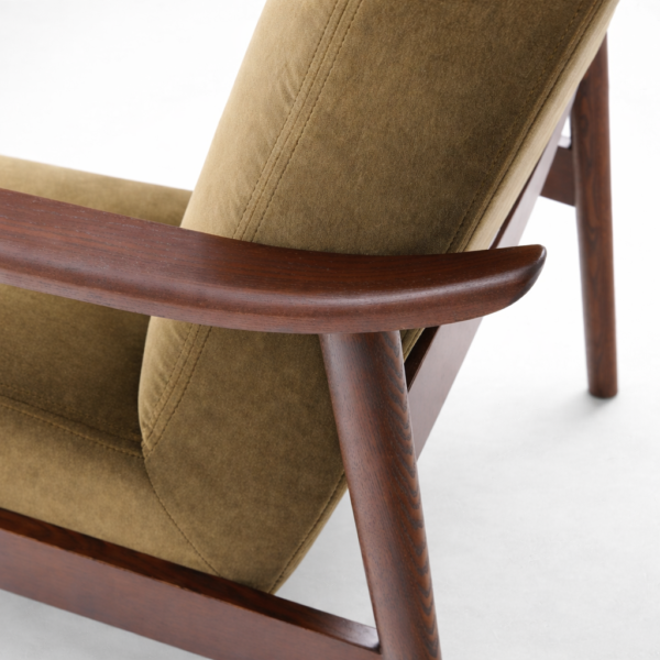 Close up of teakwood armrest and fabric upholstery lounge chair