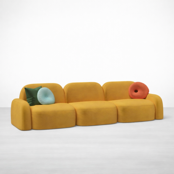 Front angled view of INTERIORZE Navya mustard yellow modular 3 seater sofa with curved arms and colourful cushions