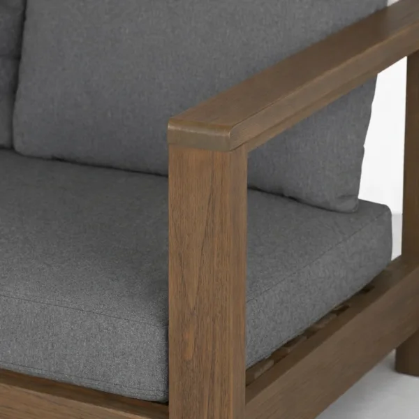 Teakwood outdoor sofa arm rail detail with charcoal cushion by INTERIORZE