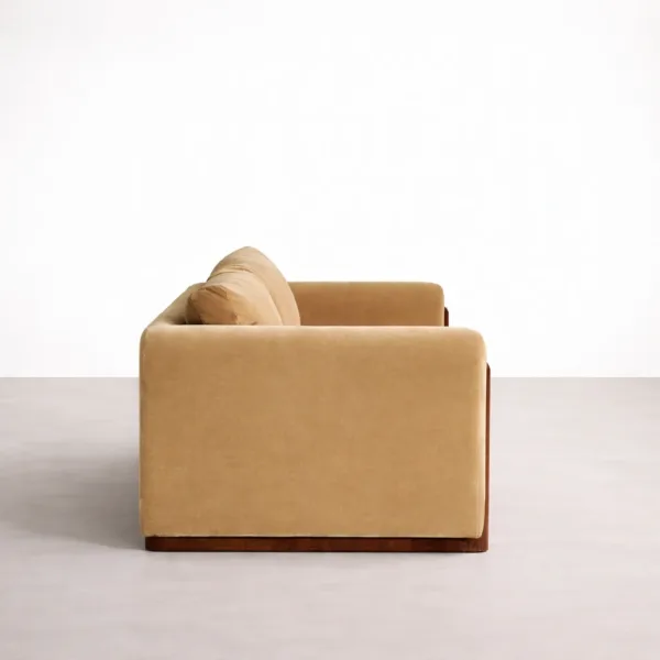 Side view of beige velvet sofa showing wooden side rail and deep seat cushion