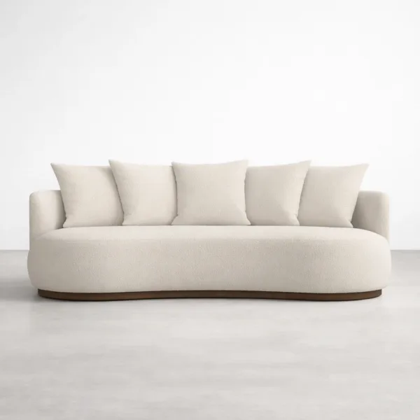 Front view of ivory boucle curved sofa with teakwood base by INTERIORZE