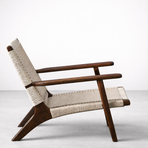 Side view of INTERIORZE woven wooden lounge chair in teak with low reclined frame