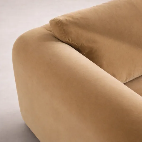 Beige velvet sofa arm close-up showing smooth velvet texture and rounded edge