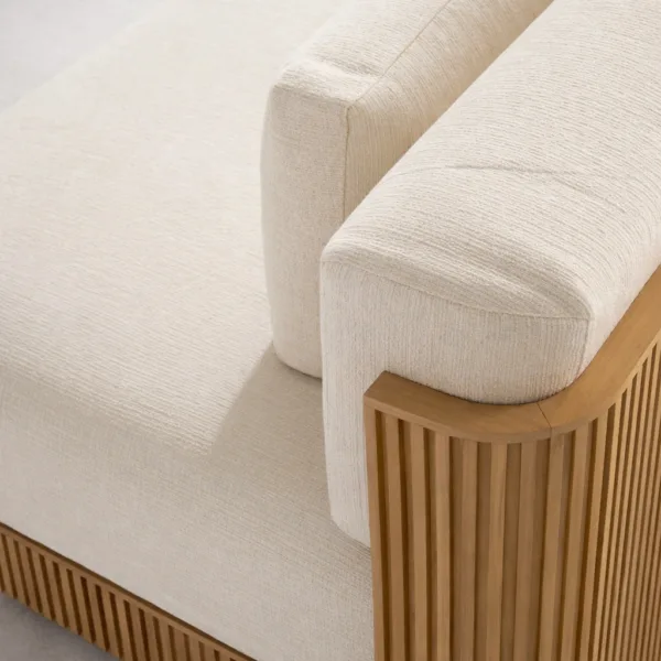 Close up of ivory upholstery and fluted teak arm of INTERIORZE Aarav teak wood 3 seater sofa