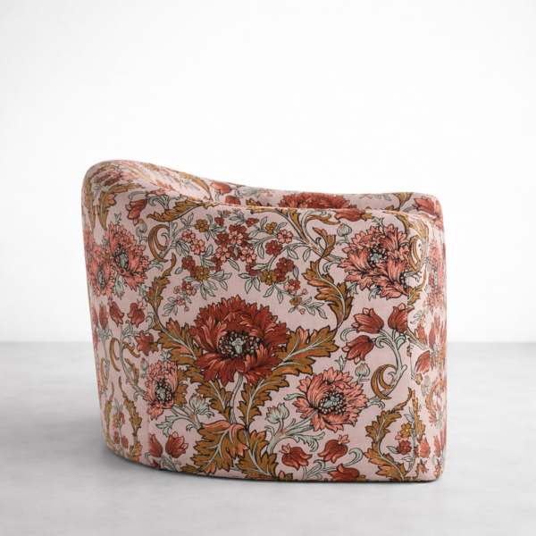 Floral swivel chair rear angle view showing curved back and side profile