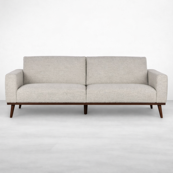 Front view of beige fabric sofa with teakwood base and comfortable cushions by INTERIORZE