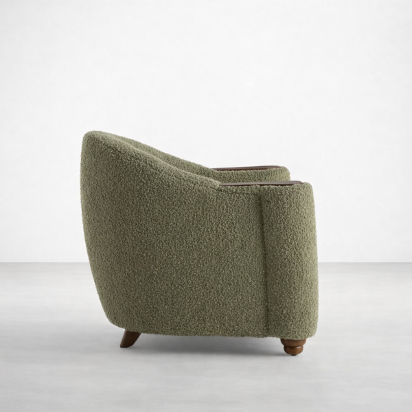 Side profile of olive green boucle lounge chair on wooden legs