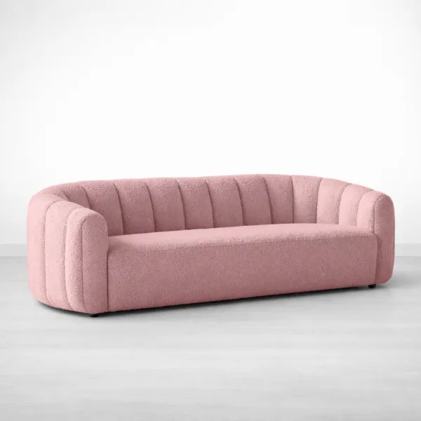 Front angled view of INTERIORZE Aisha pink boucle 3 seater sofa with rounded arms and cocoon shape