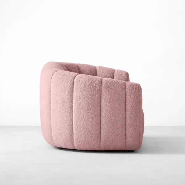 Side view of INTERIORZE Aisha pink boucle 3 seater sofa with curved arm and channel side