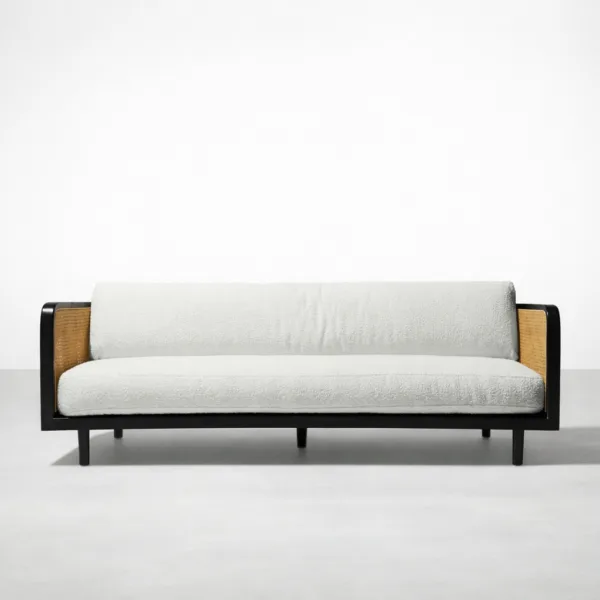 Front view of INTERIORZE Vihaan teak wood cane 3 seater sofa with black frame, cane sides and ivory boucle cushions
